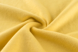 Dettaglio del tessuto in maglia giallo brillante con trama morbida e traspirante