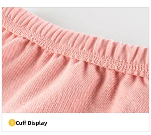 Detailed close-up of pink knitted sleeve cuff with elastic ribbing and reinforced stitching