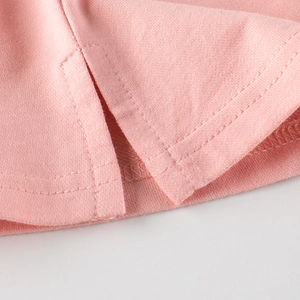 Pink knit underskirt with side slit detail and reinforced double-needle stitching