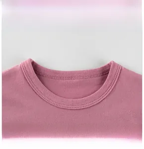 Detailed close-up of the round neckline and fine stitching on pink cotton toddler T-shirt