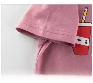 Detail of pink cotton T-shirt sleeve with high-quality double stitching and cartoon print
