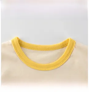 Close-up of beige cotton T-shirt featuring a contrast yellow ribbed crew neck collar