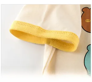 Detail of yellow ribbed cuff on a cream cotton kids t-shirt with cute bear prints