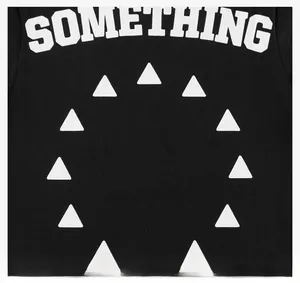 Detail of white SOMETHING text and geometric circle print on black cotton t-shirt