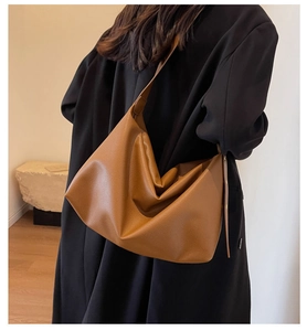 Detail of caramel brown tote bag with premium lychee grain texture and wide strap