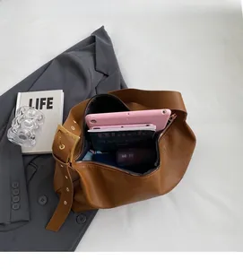 Top view of brown lychee grain leather hobo bag showing spacious interior capacity