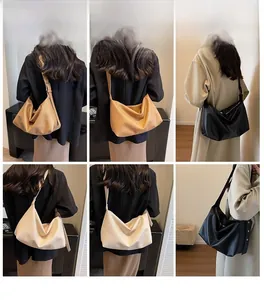 Detail view of large matte leather hobo bag in dark coffee and beige colors