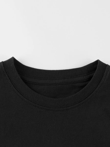 Classic black crew neck boys cotton T-shirt showing detailed ribbed neckline and stitching