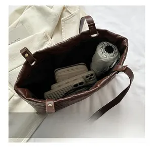 Large capacity coffee quilted tote bag showing interior space for umbrella and phone
