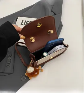 Internal view of a bicolor flap shoulder bag showing space for a smartphone and accessories