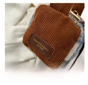 Detail of brown corduroy and faux shearling textures on the fashionable crossbody bag