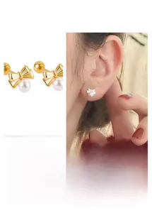 Detailed view of bow knot pearl earrings with secure screw back closure and gold finish