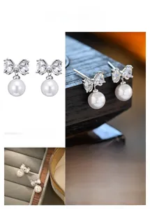 Detail of bow-shaped pearl earrings with cubic zirconia inlay in elegant silver plating