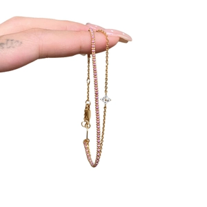 Double-layer gold clover bracelet with pink gemstones and white floral charms