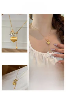 Close-up of brushed gold heart necklace with a sparkling diamond inlay for women