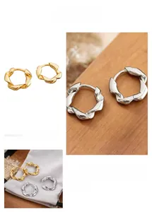 Detailed close-up of geometric twisted hoop earrings in gold and silver finishes