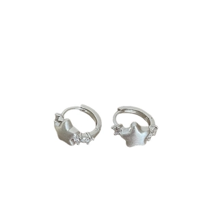 Star-shaped silver earrings with matte finish and tiny embedded crystals on white background