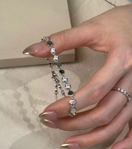 Detail of vintage round diamond bracelet and ring set with sparkling zircon stones