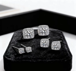 Close-up of three sizes of geometric square stud earrings with pave-set shimmering crystals