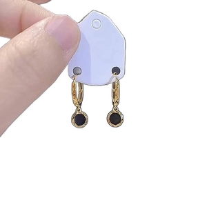 Elegant gold-plated hoop earrings featuring a minimalist black round enamel disc pendant