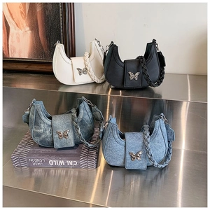Detailed display of crescent denim and leather underarm bags with butterfly buckles