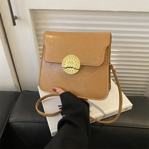 Classic khaki square crossbody bag with large metallic round buckle and leather strap