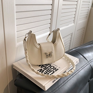 Chic beige crescent shoulder bag with silver butterfly buckle and woven strap
