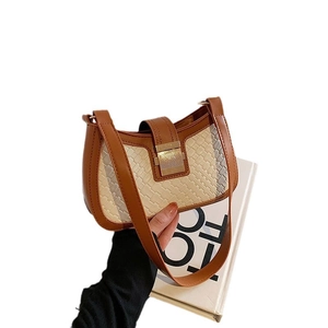 Chic two-tone shoulder bag with beige woven fabric, brown leather trim and gold buckle
