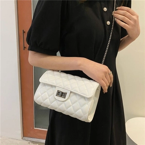 Classic white quilted crossbody bag with silver chain strap and metallic twist-lock
