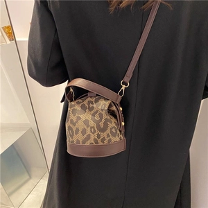 Vintage leopard print bucket bag with brown leather trim and crossbody strap