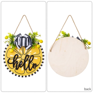 Front and back detail of a yellow wooden lemon door sign with hello lettering and bow