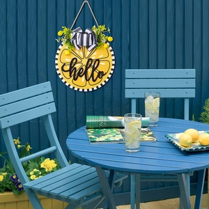 Detail of wooden Hello lemon door hanger with striped bow and lifelike greenery