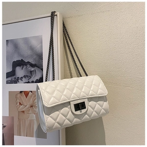 Detail of white quilted crossbody bag with dark grey metal chain and twist lock