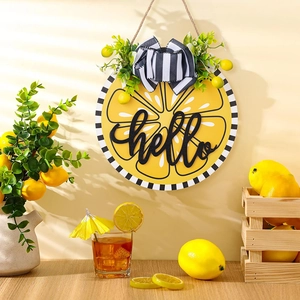 Detailed view of hello lemon wreath with buffalo plaid bow and greenery on wooden sign