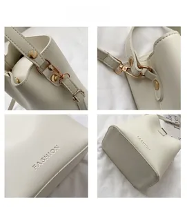 Detail view of cream bucket bag with lychee texture, gold hardware, and FASHION logo