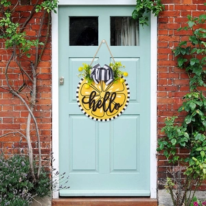 Close-up of hello welcome sign with lemon patterns and striped bow on a wooden door