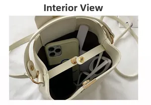 Interior view of cream bucket bag showing snap button closure and spacious compartment