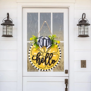 Detailed view of hello lemon door sign with striped bow and green leaves on white door