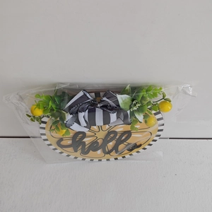 Close-up of Hello Summer lemon door sign with black-white bow and faux greenery décor
