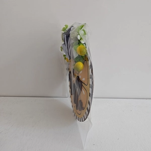 Side view of wooden lemon welcome sign in clear packaging with green leaf accents