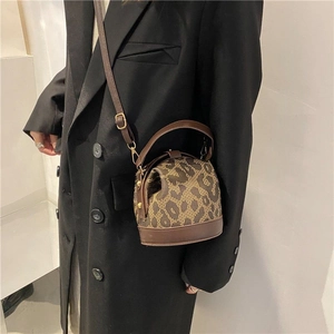 Retro leopard print crossbody bucket bag with leather handles and gold-tone hardware