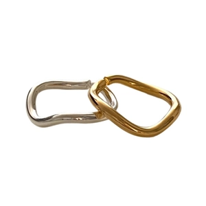 Minimalist interlocking wavy rings in gold and silver finish on a clean white background