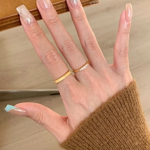 Minimalist gold ring set featuring a textured star band and sparkling diamond row
