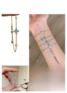 Detail of four-leaf clover bracelets with blue floral accents and shimmering zircons