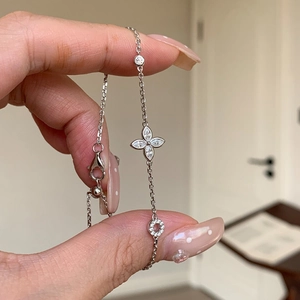 Detailed view of silver clover bracelet with sparkling marquise cut zircon on wrist
