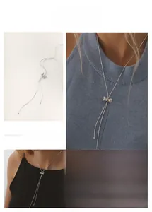 Detail of adjustable silver bow knot necklace showing the pull-string slider mechanism