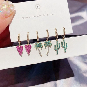 Detail of Korean style earrings set featuring pink heart, palm tree, and cactus charms