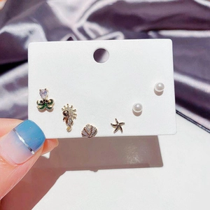 Detailed set of sea-themed earrings featuring starfish, seahorse, and shell with purple stones