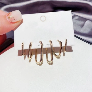 Close-up of gold-plated U-shaped earrings on a Silver Post display card with a velvet background