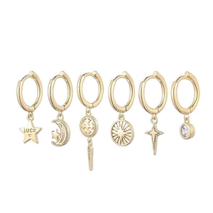 Detail of 6-piece gold hoop earring set featuring star, moon, and LUCK engraved charms